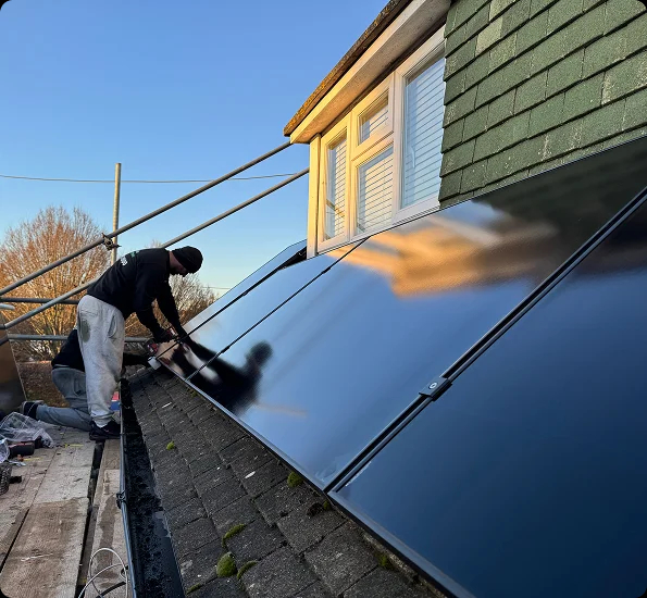 Engineer installing solar panels on roof